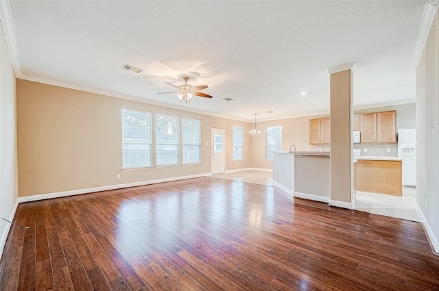 unfurnished living room featuring light hardwood / wood-style floors, ceiling fan, and crown molding