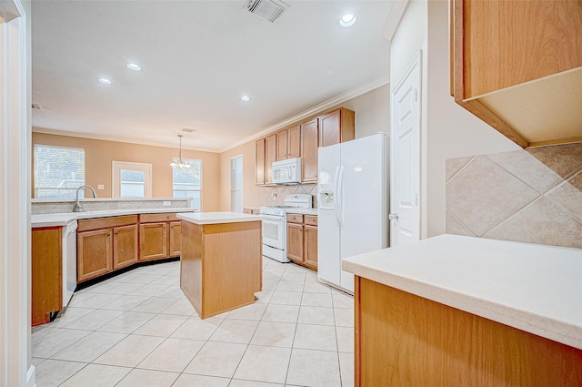 kitchen featuring backsplash, ornamental molding, white appliances, decorative light fixtures, and a kitchen island