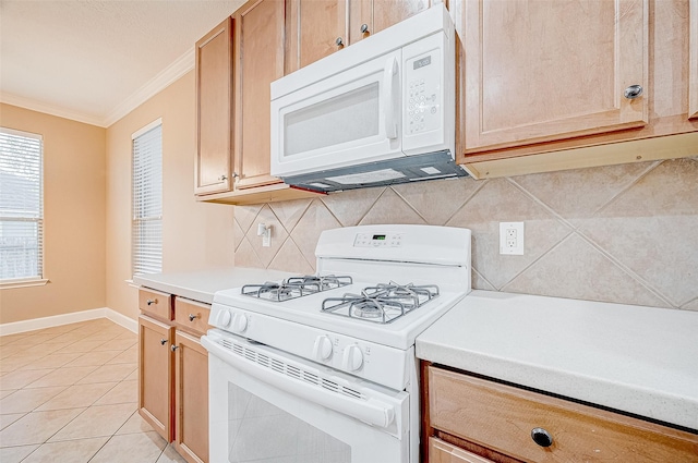 kitchen with decorative backsplash, crown molding, light tile patterned flooring, and white appliances