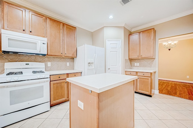 kitchen with white appliances, crown molding, light tile patterned floors, an inviting chandelier, and a center island