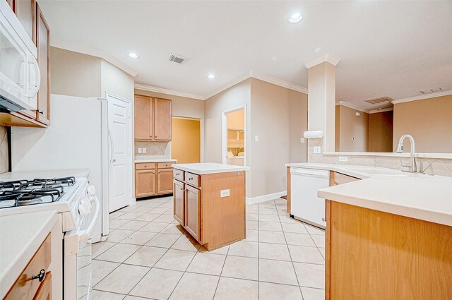 kitchen featuring a center island, sink, crown molding, white appliances, and light tile patterned floors