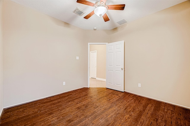 unfurnished room featuring ceiling fan, hardwood / wood-style floors, and a textured ceiling