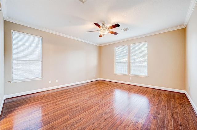 unfurnished room with ceiling fan, ornamental molding, a healthy amount of sunlight, and hardwood / wood-style flooring