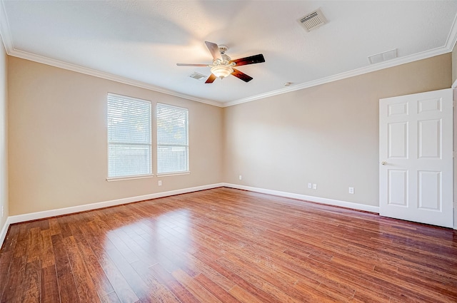 spare room with crown molding, ceiling fan, and wood-type flooring