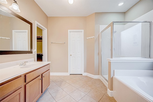 bathroom with tile patterned flooring, shower with separate bathtub, and vanity