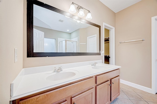 bathroom with tile patterned floors, vanity, and an enclosed shower