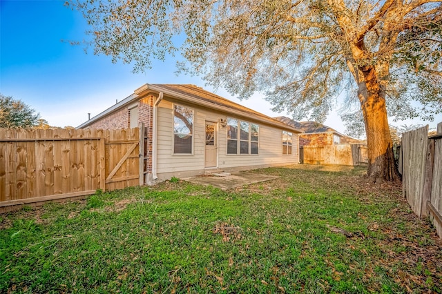 rear view of house with a lawn