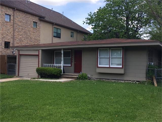 view of front of house with a porch, a garage, and a front lawn