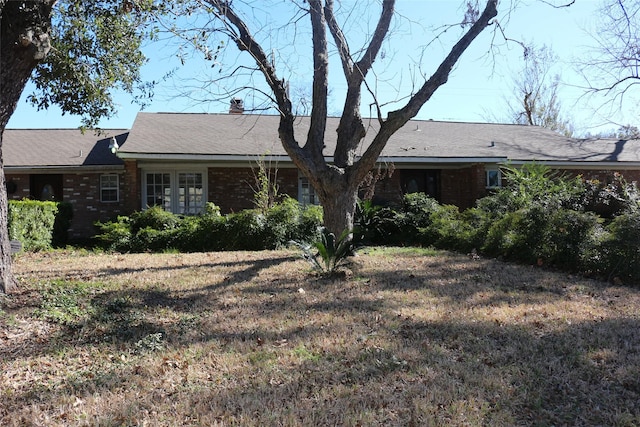 rear view of property featuring a yard