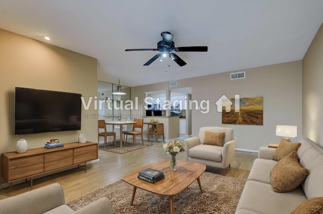 living room with ceiling fan and light wood-type flooring