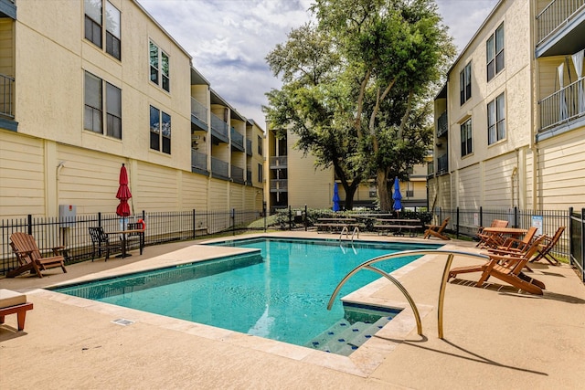 view of swimming pool with a patio