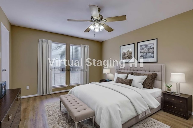 bedroom with light hardwood / wood-style flooring and ceiling fan