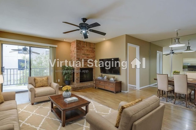 living room with a fireplace and light wood-type flooring