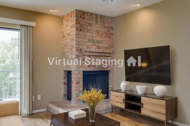 living room featuring a fireplace and hardwood / wood-style floors