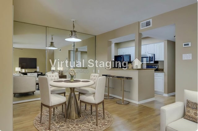 dining area featuring light hardwood / wood-style floors and ceiling fan