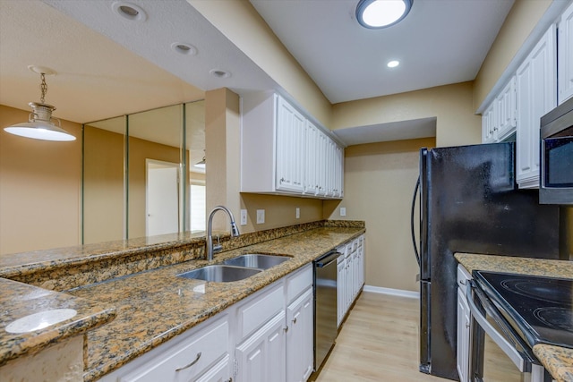 kitchen featuring white cabinetry, sink, hanging light fixtures, and appliances with stainless steel finishes