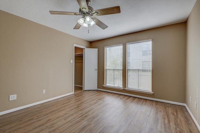 empty room featuring ceiling fan and hardwood / wood-style flooring