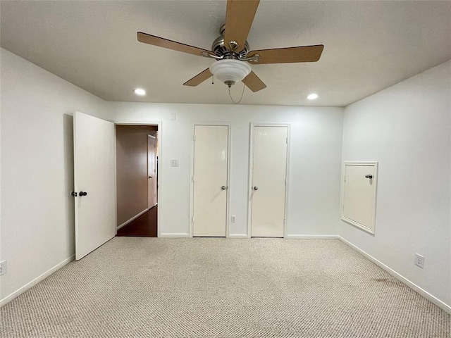 unfurnished bedroom with ceiling fan and light carpet