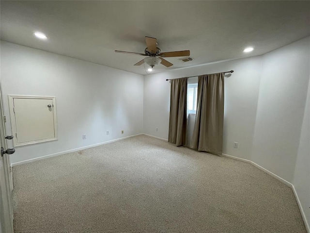 carpeted spare room featuring ceiling fan