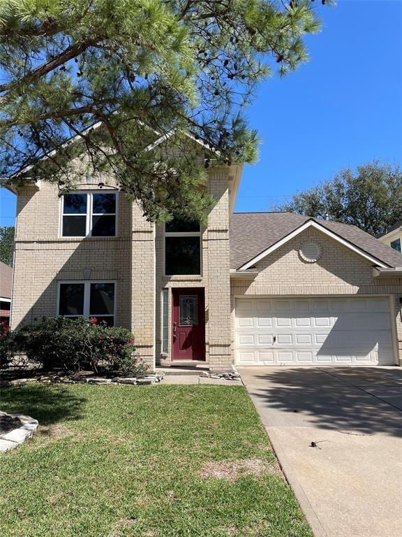 view of front of house with a garage and a front yard