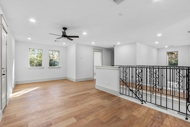 empty room featuring ceiling fan and light hardwood / wood-style flooring