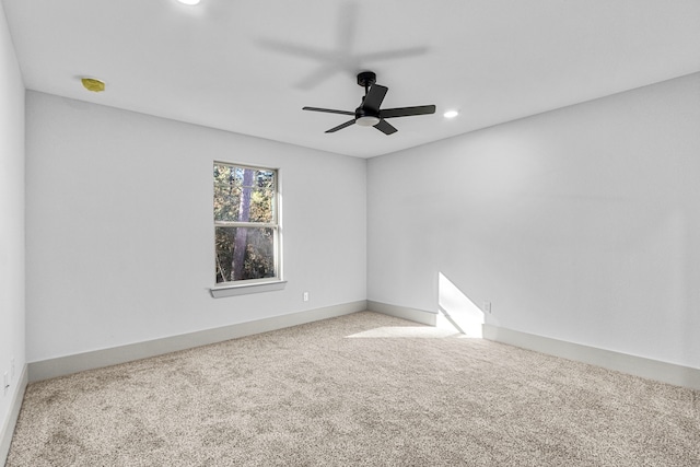 carpeted empty room featuring ceiling fan