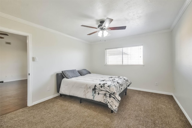 carpeted bedroom with ornamental molding and ceiling fan