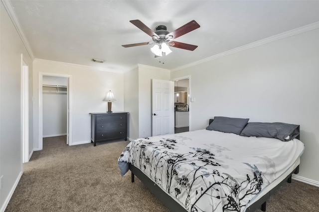 bedroom featuring crown molding, carpet floors, a closet, and a spacious closet