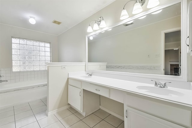 bathroom with tile patterned flooring, vanity, and a bathtub