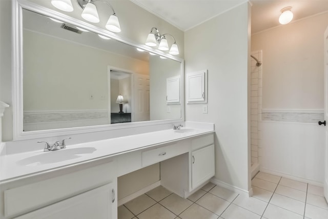 bathroom with vanity, tile patterned floors, and tiled shower