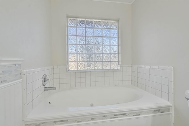 bathroom featuring tiled tub