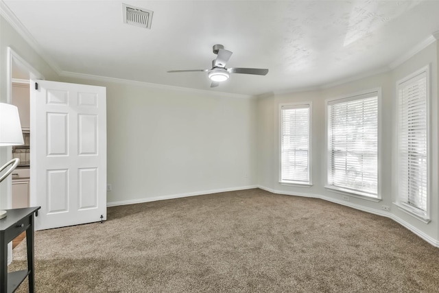 carpeted empty room featuring ornamental molding and ceiling fan