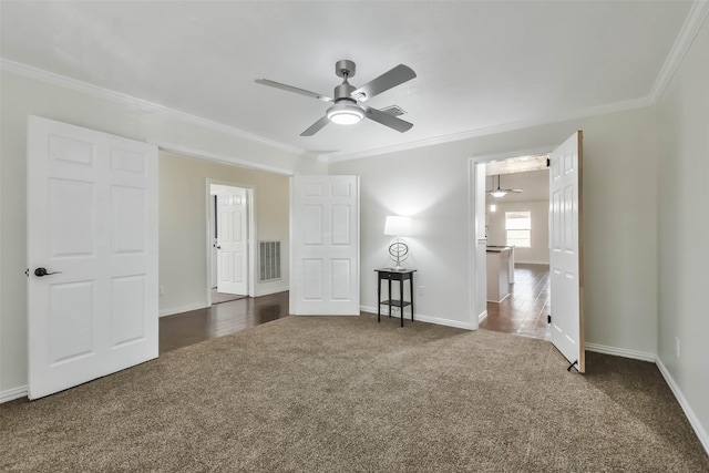 unfurnished bedroom featuring ceiling fan, ornamental molding, and dark colored carpet