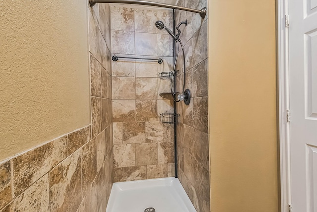 bathroom with tiled shower