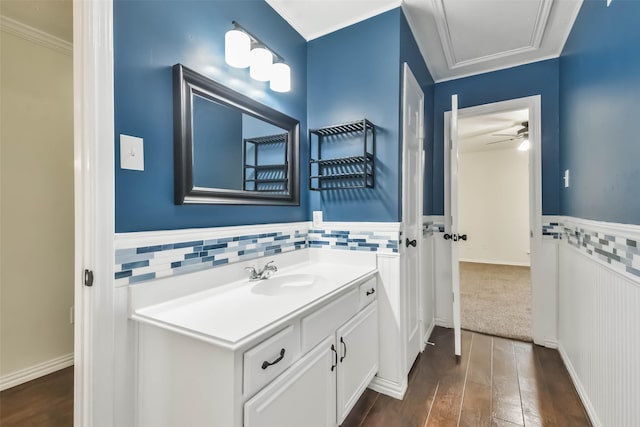 bathroom with vanity, hardwood / wood-style floors, and ornamental molding