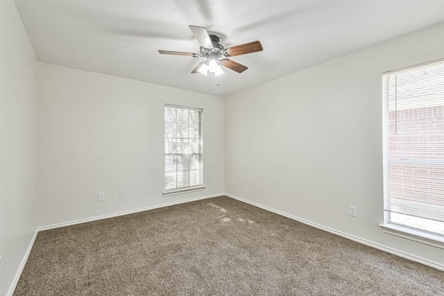 carpeted empty room with plenty of natural light and ceiling fan