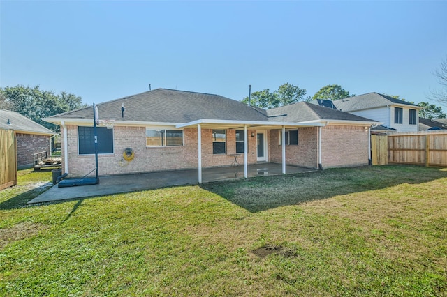 back of property with a yard and a patio area