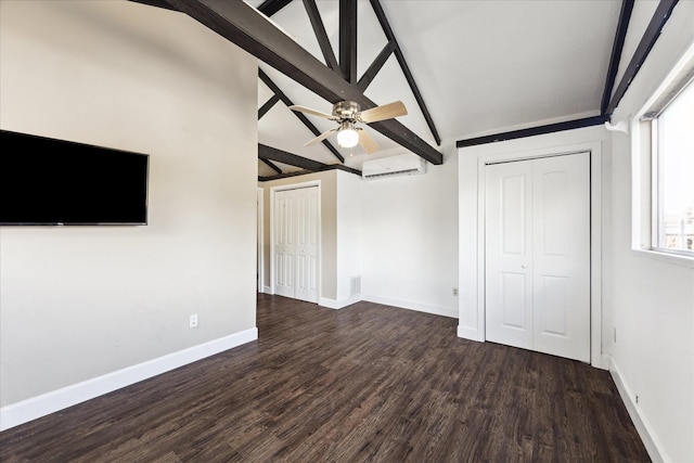 interior space featuring a wall unit AC, ceiling fan, dark hardwood / wood-style floors, and lofted ceiling with beams