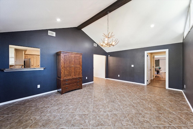 unfurnished room with vaulted ceiling with beams and an inviting chandelier