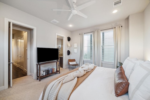 bedroom with ceiling fan and light colored carpet