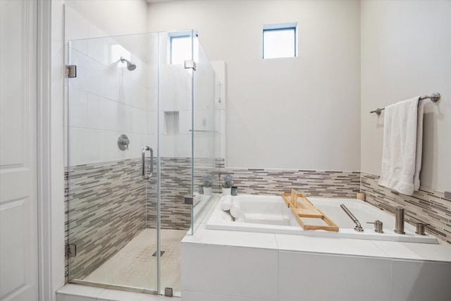 bathroom with separate shower and tub