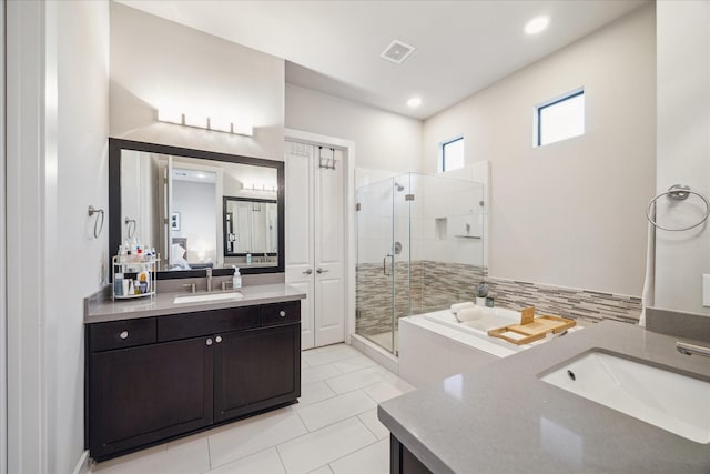 bathroom with tile patterned floors, vanity, and separate shower and tub