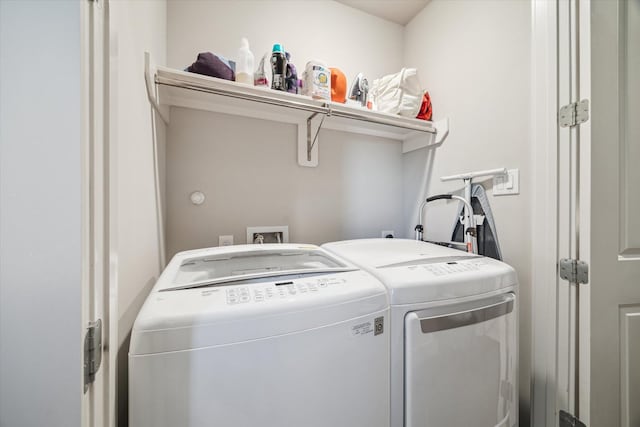 washroom with washing machine and dryer