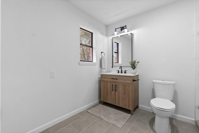 bathroom with tile patterned flooring, vanity, and toilet