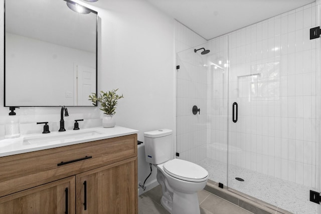 bathroom with tile patterned floors, vanity, toilet, and a shower with shower door