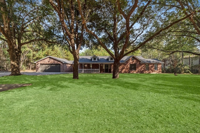 view of front facade with covered porch, a garage, and a front lawn