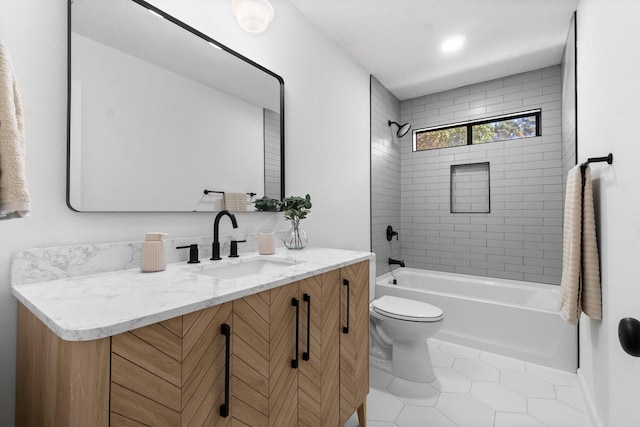 full bathroom with tile patterned flooring, vanity, toilet, and tiled shower / bath