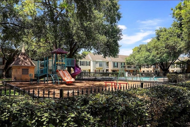 view of jungle gym with a community pool