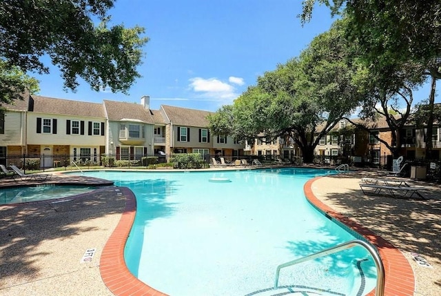 view of pool with a community hot tub and a patio