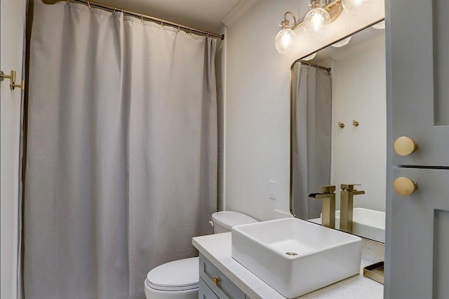 bathroom with vanity, toilet, and crown molding